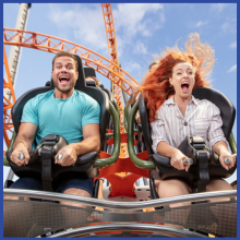 A man and a woman are shouting as they ride a rollercoaster at Dreamworld